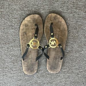 Black and gold Michael Joe’s flip flops